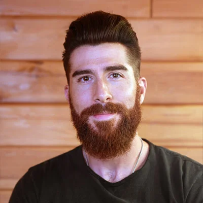 A bearded man with a Pompadour haircut.