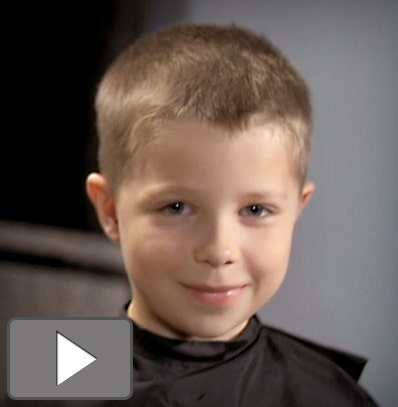 A boy with a crew cut haircut.