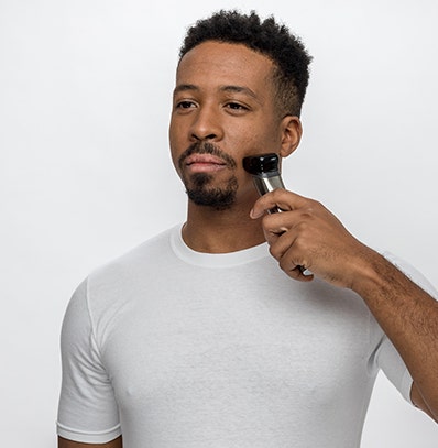 A man shaping his goatee with a Wahl trimmer. 