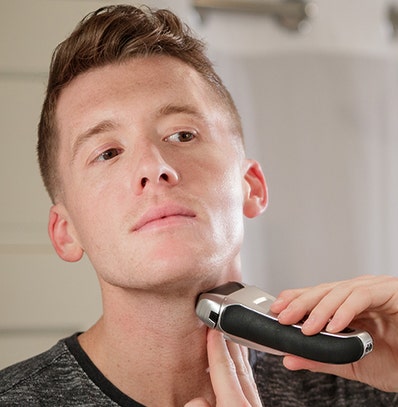 Man shaving his neck with a Wahl shaver.