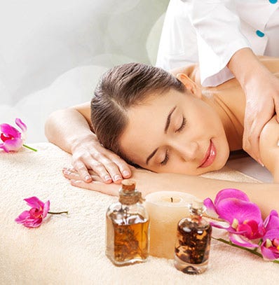 A woman getting a massage at a spa. 