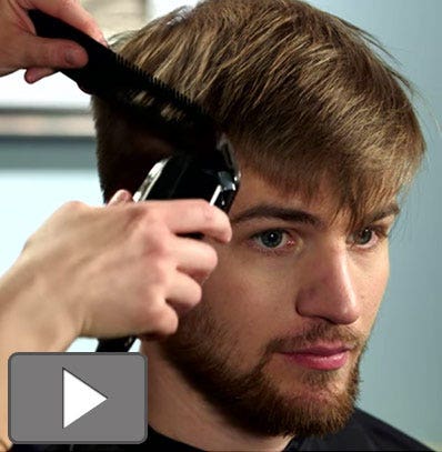 Using a comb as a guide for haircutting. 