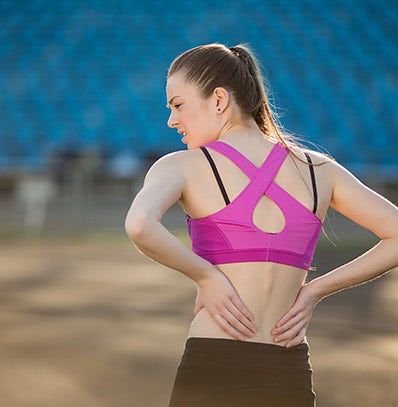 A woman catching her breath during a workout. 