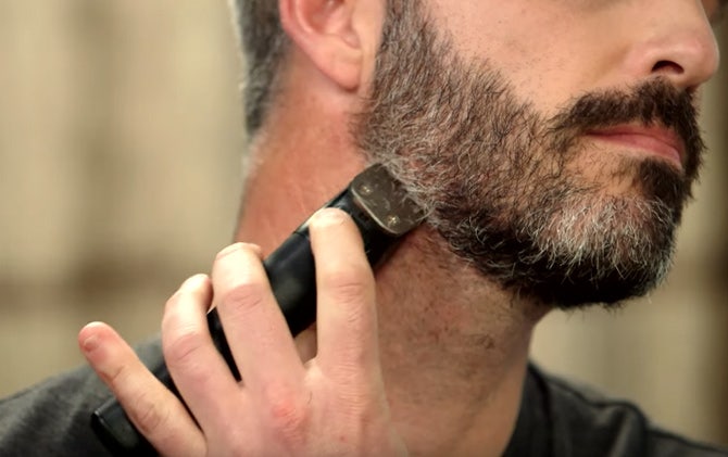 A man lining his beard with a Wahl trimmer. 